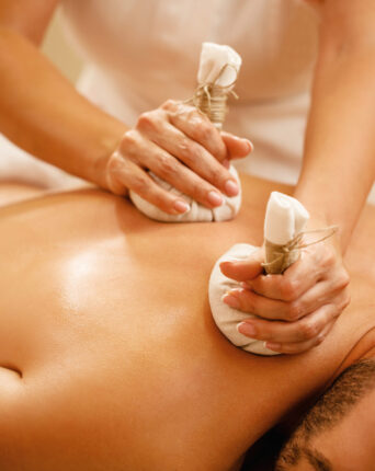 image of the hands of a healer at dune healing center making an Abhyangam massage